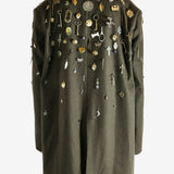 Green coat worn by a person, showing the coat fit