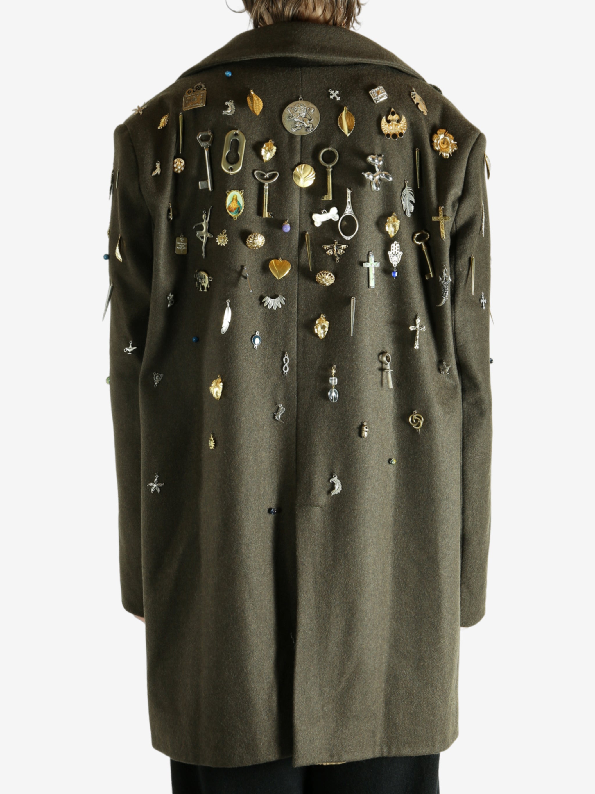 Green coat worn by a person, showing the coat fit