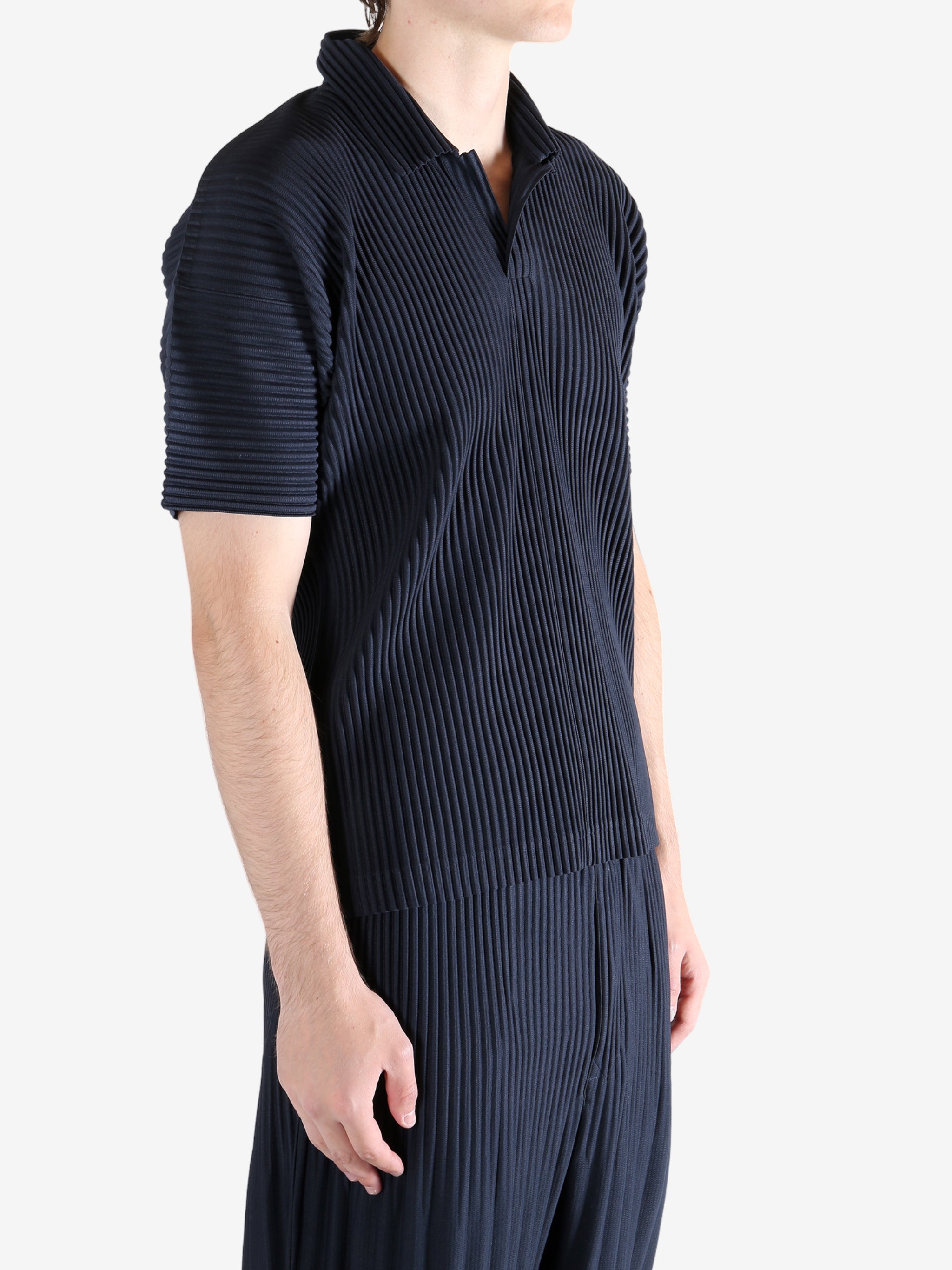 Navy shirt worn by a person, showing the shirt's fit