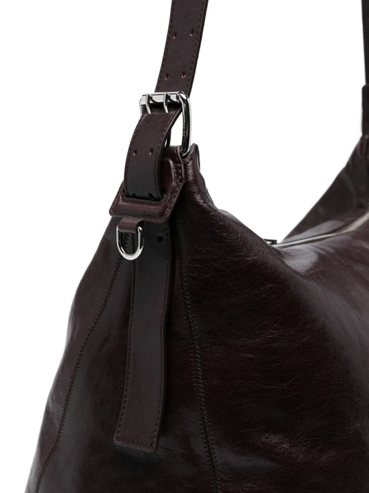 close up of brown bags, showing texture of the leather  fabric