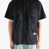 Black shirts worn by a person, showing the shirts fit