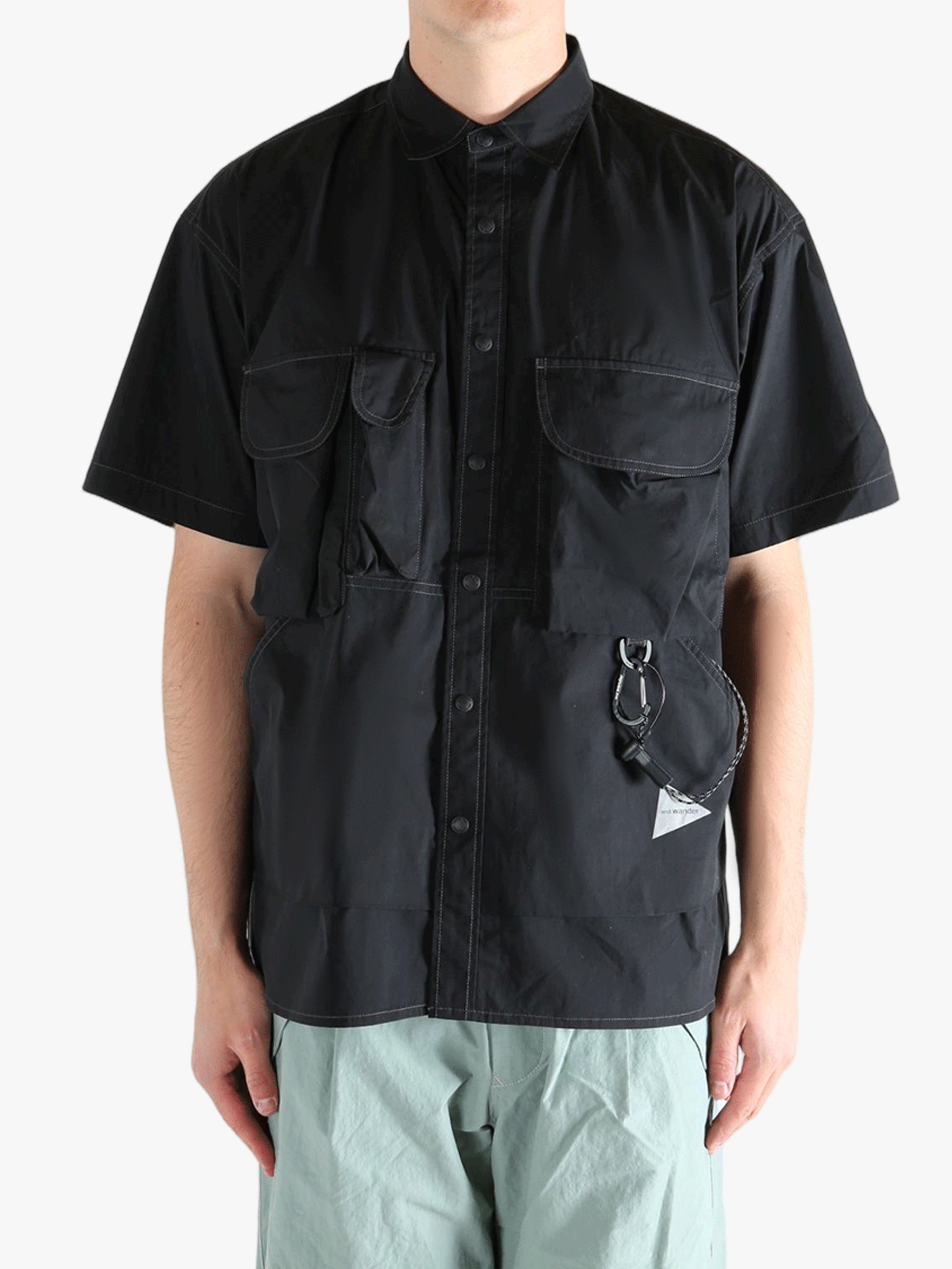 Black shirts worn by a person, showing the shirts fit