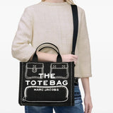 Black bag carried by a person, showing the bag’s style