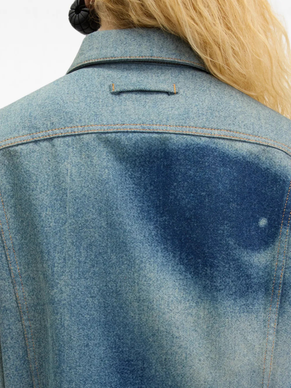 Blue jacket worn by a person, showing the jacket fit