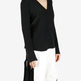 Black top worn by a person, showing the top's fit