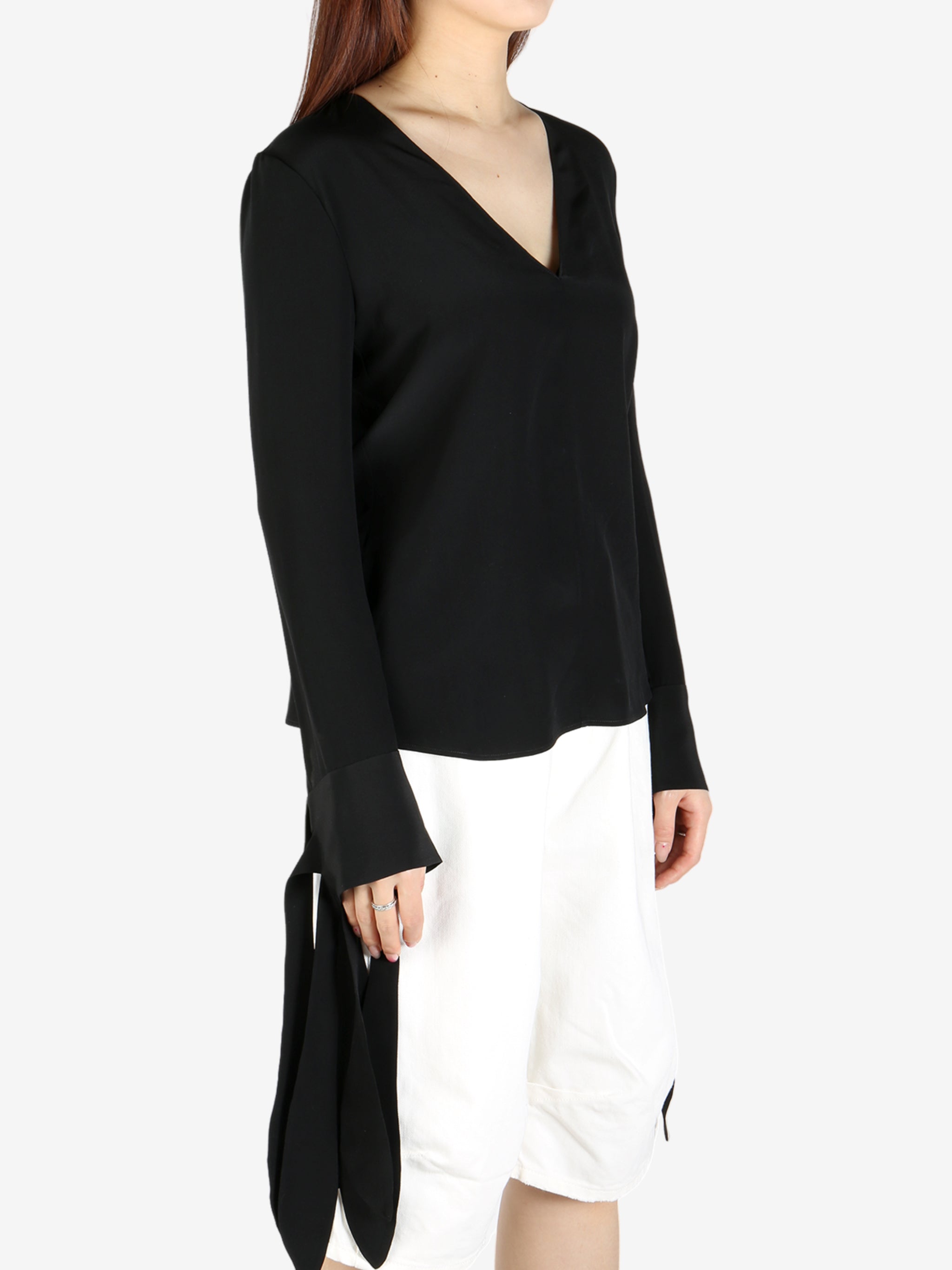 Black top worn by a person, showing the top's fit