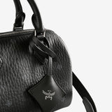 Close up of black bag, showing texture of the leather fabricr