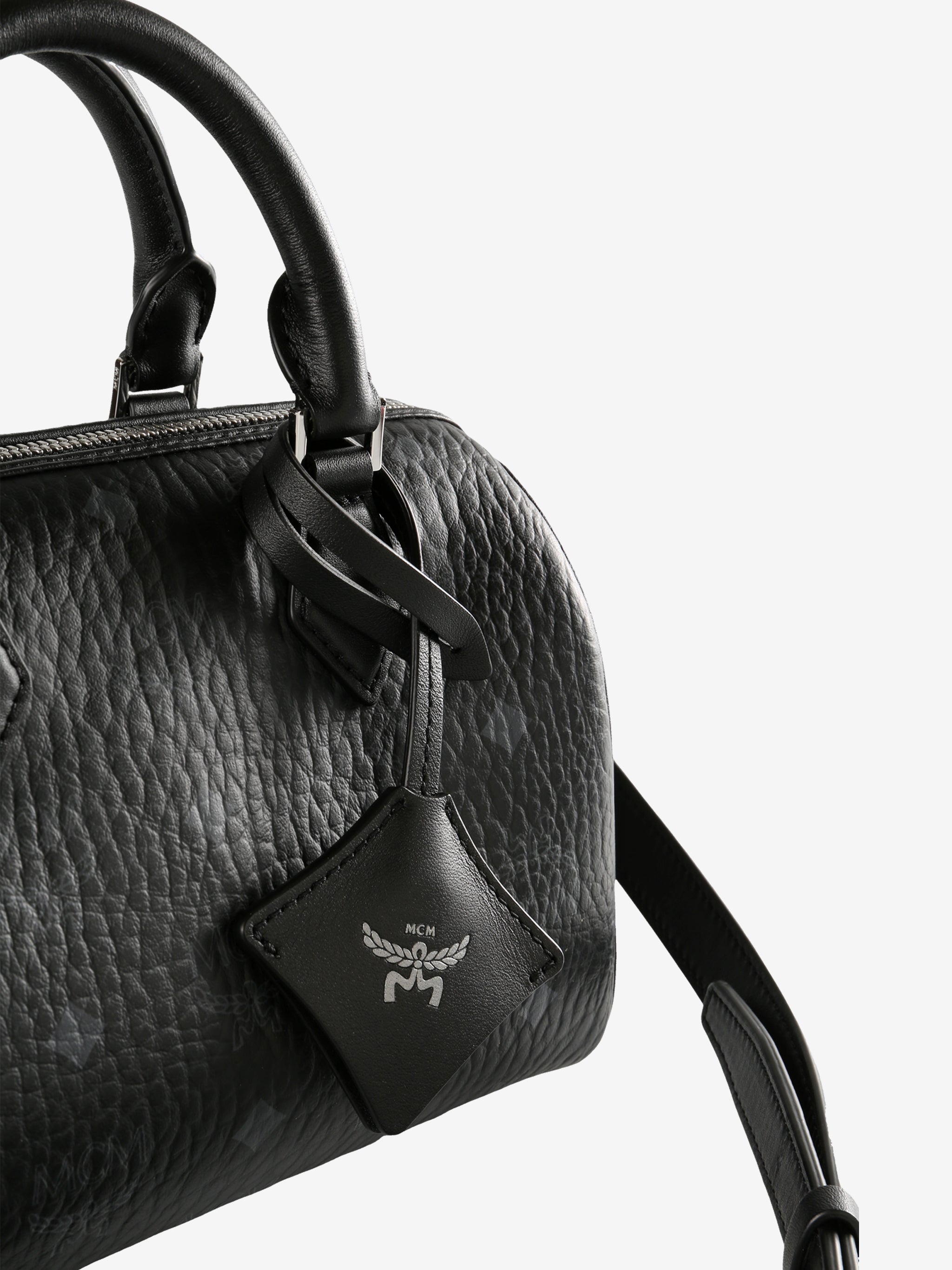 Close up of black bag, showing texture of the leather fabricr