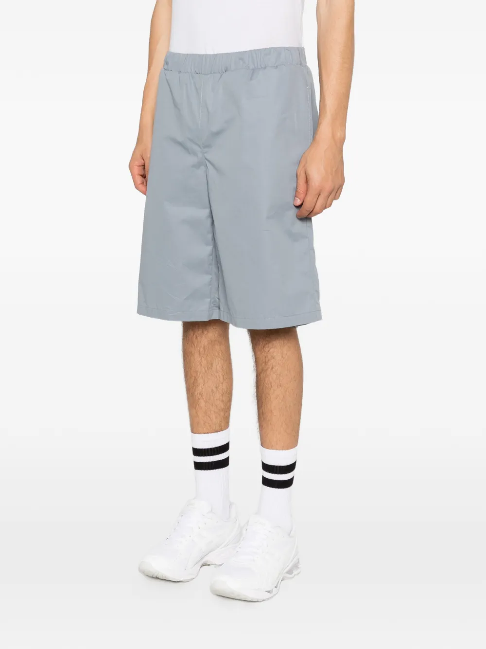 Grey shorts worn by a person, showing the shorts fit