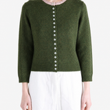 Green knitwear worn by a person, showing the knitwear fit