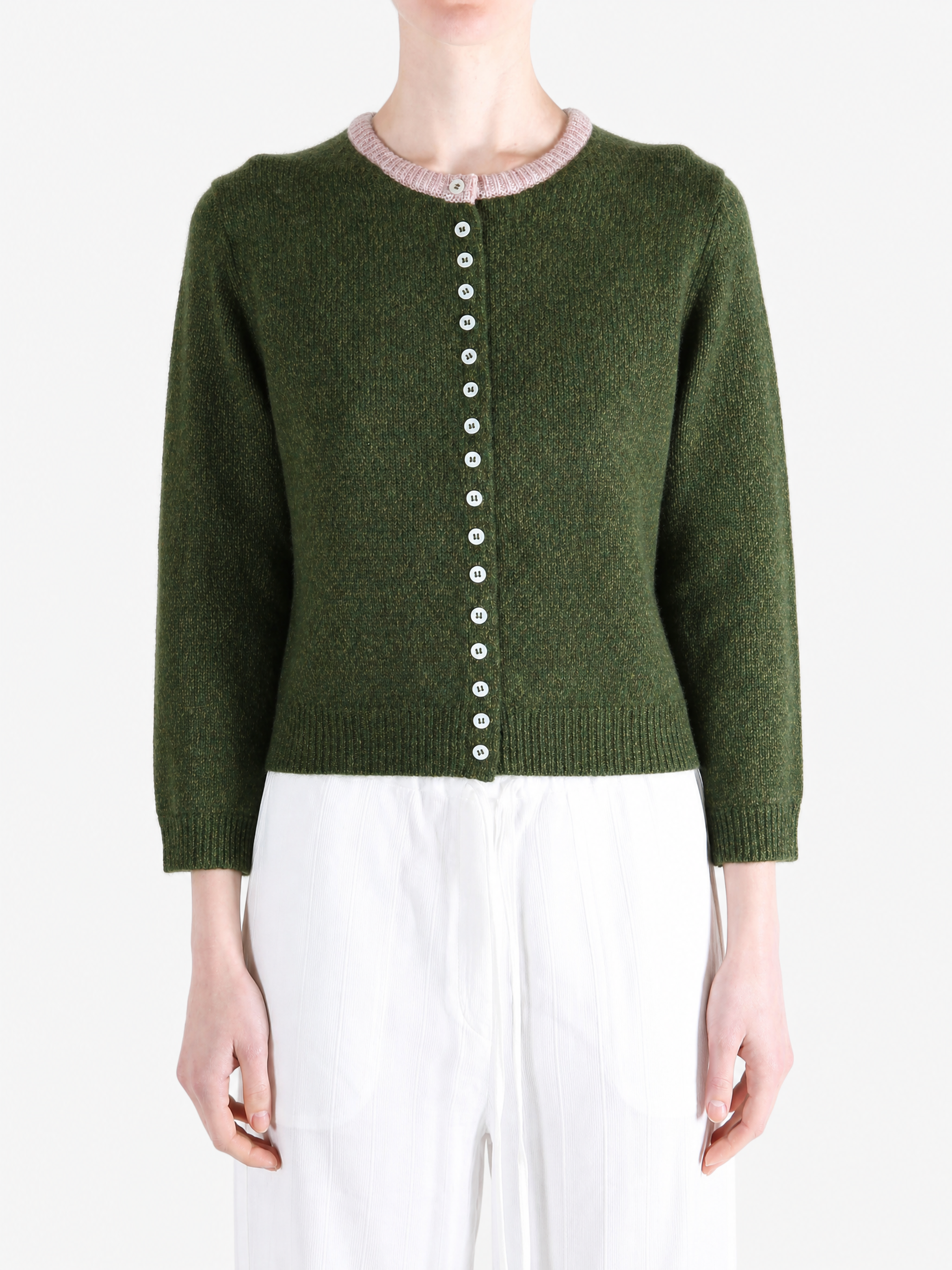 Green knitwear worn by a person, showing the knitwear fit