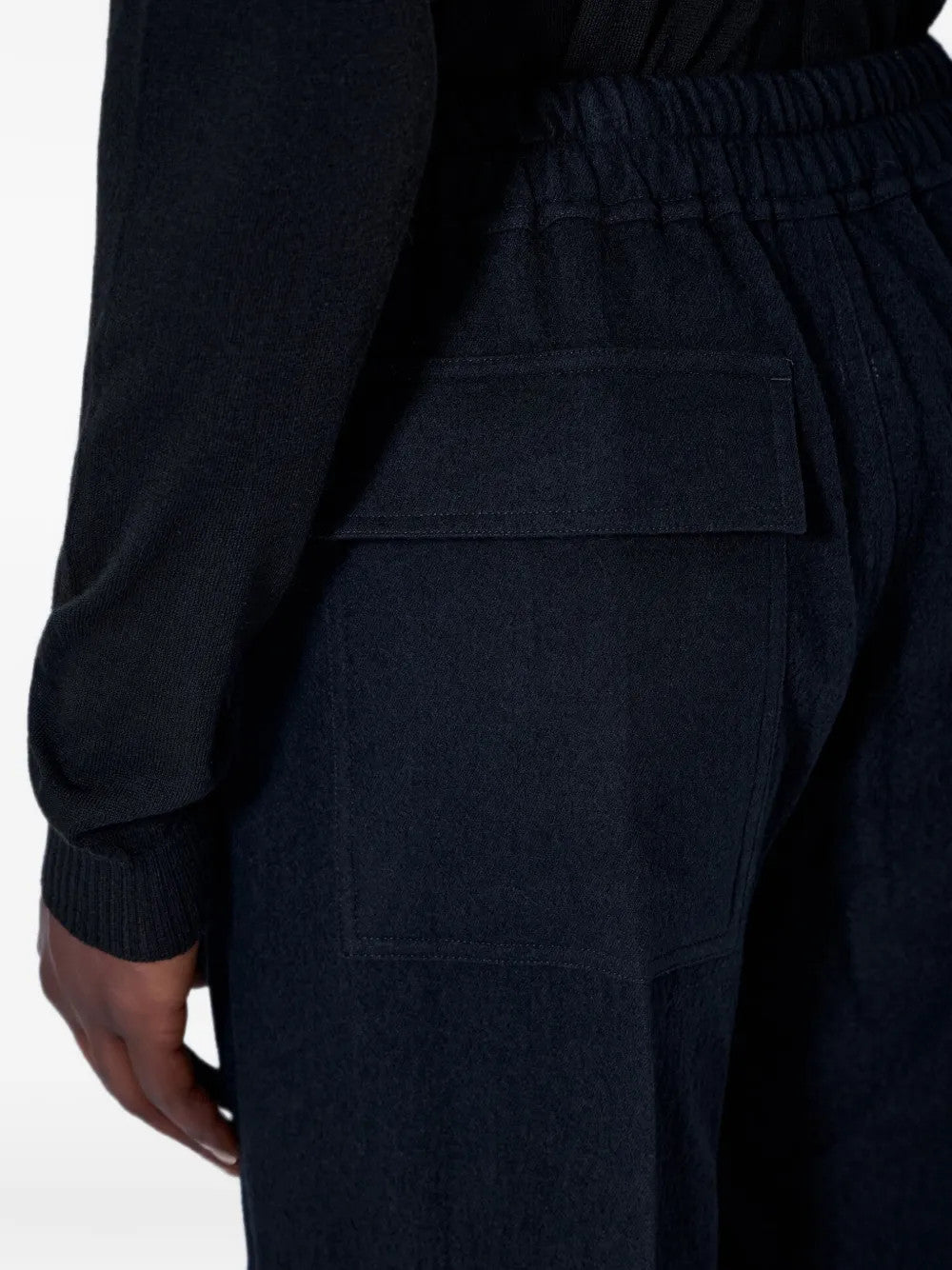 Black pants worn by a person, showing the pants fit