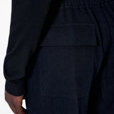 Black pants worn by a person, showing the pants fit
