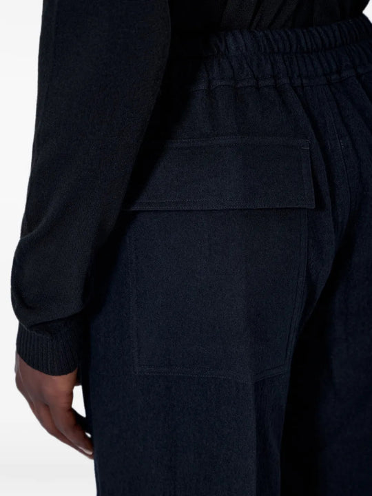 Black pants worn by a person, showing the pants fit