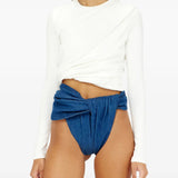 White top worn by a person, showing the top fit