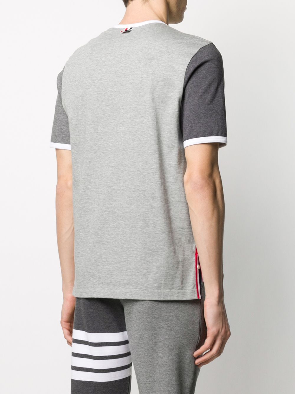 Grey T-shirt worn by a person, showing the shirt’s fit