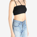 Black tops worn by a person, showing the tops fit