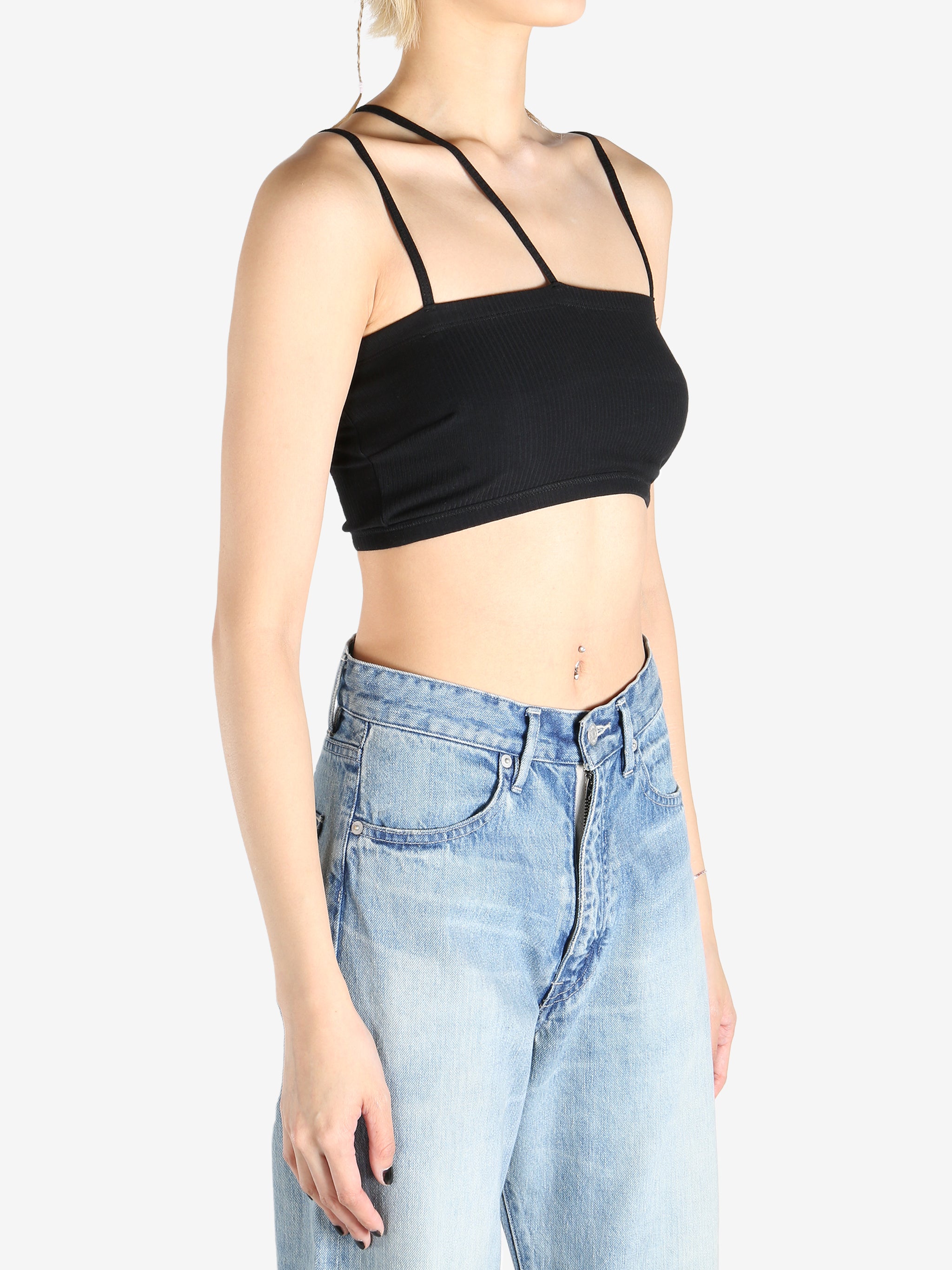 Black tops worn by a person, showing the tops fit