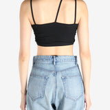 Black tops worn by a person, showing the tops fit