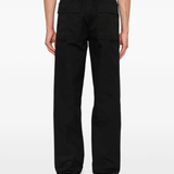 Black pants worn by a person, showing the pants's fit