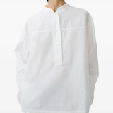 White shirt worn by a person, showing the shirt's fit