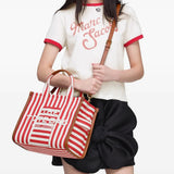 Red bag worn by a person, showing the bag's fit