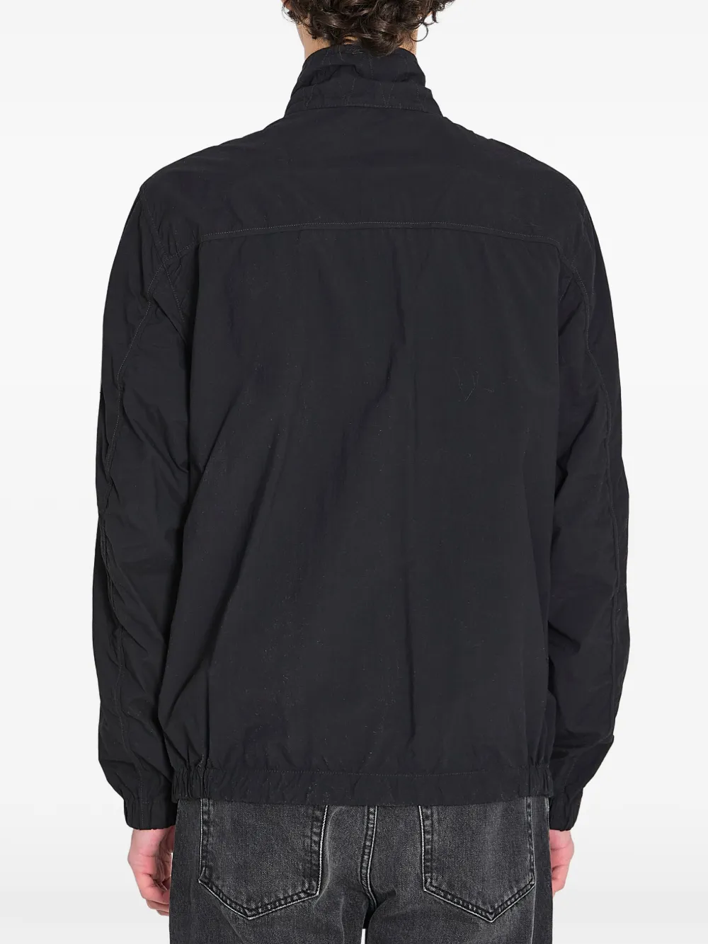 Black jacket worn by a person, showing the black jacket's fit