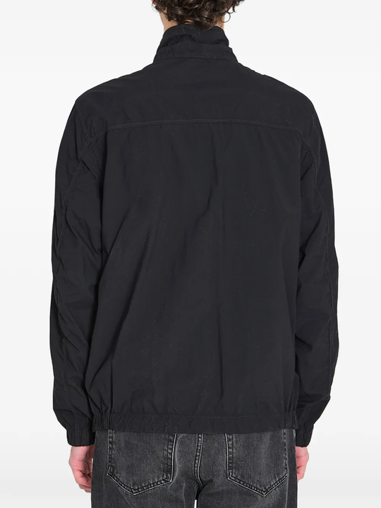 Black jacket worn by a person, showing the black jacket's fit