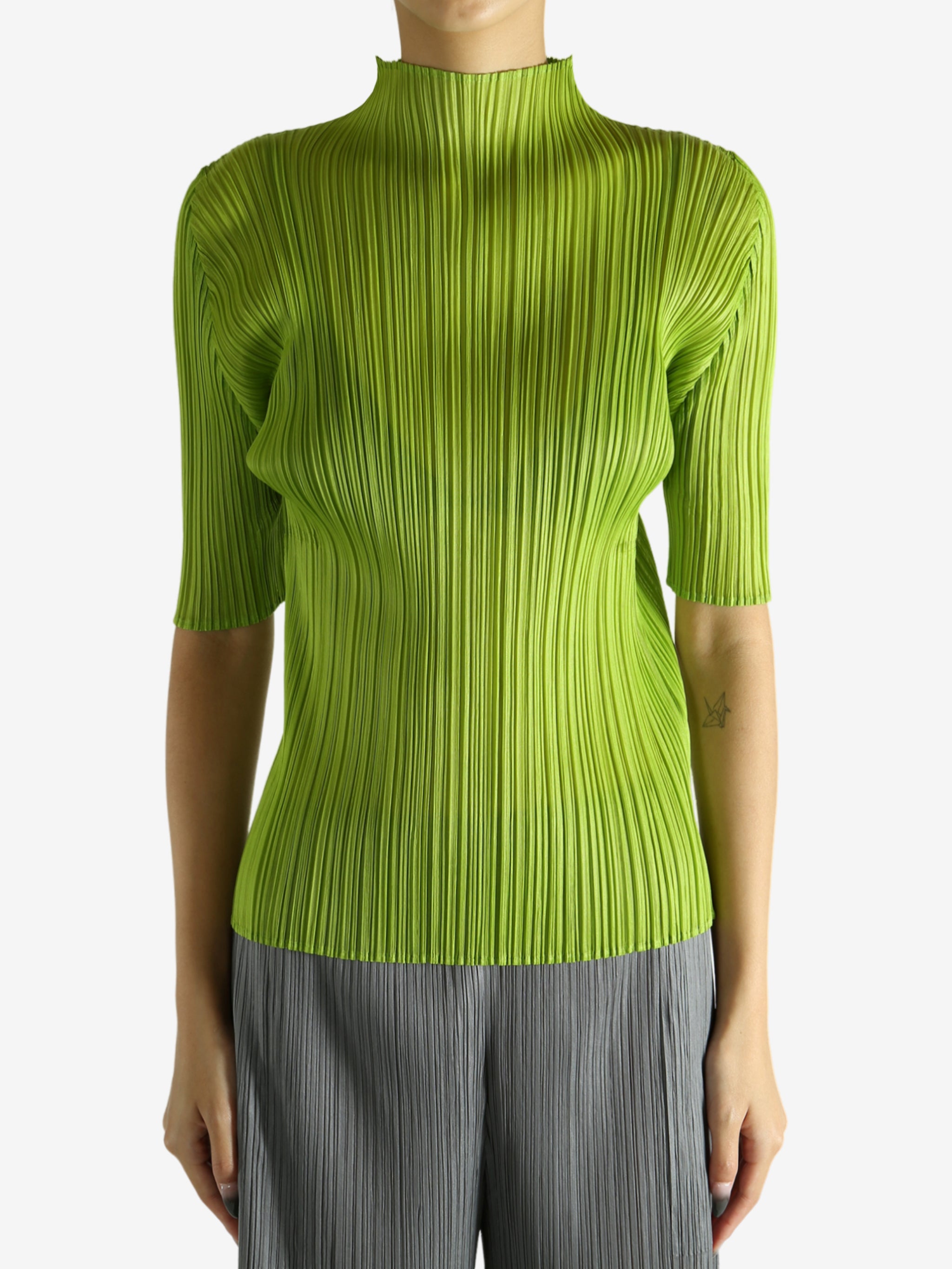 Green shirt worn by a person, showing the shirt's fit