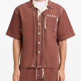 Brown shirt worn by a person, showing the shirt fit