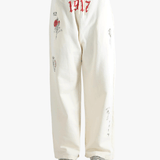 White pants worn by a person, showing the pants fit