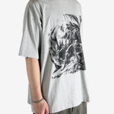 Grey t-shirt worn by a person, showing the shirt's fit