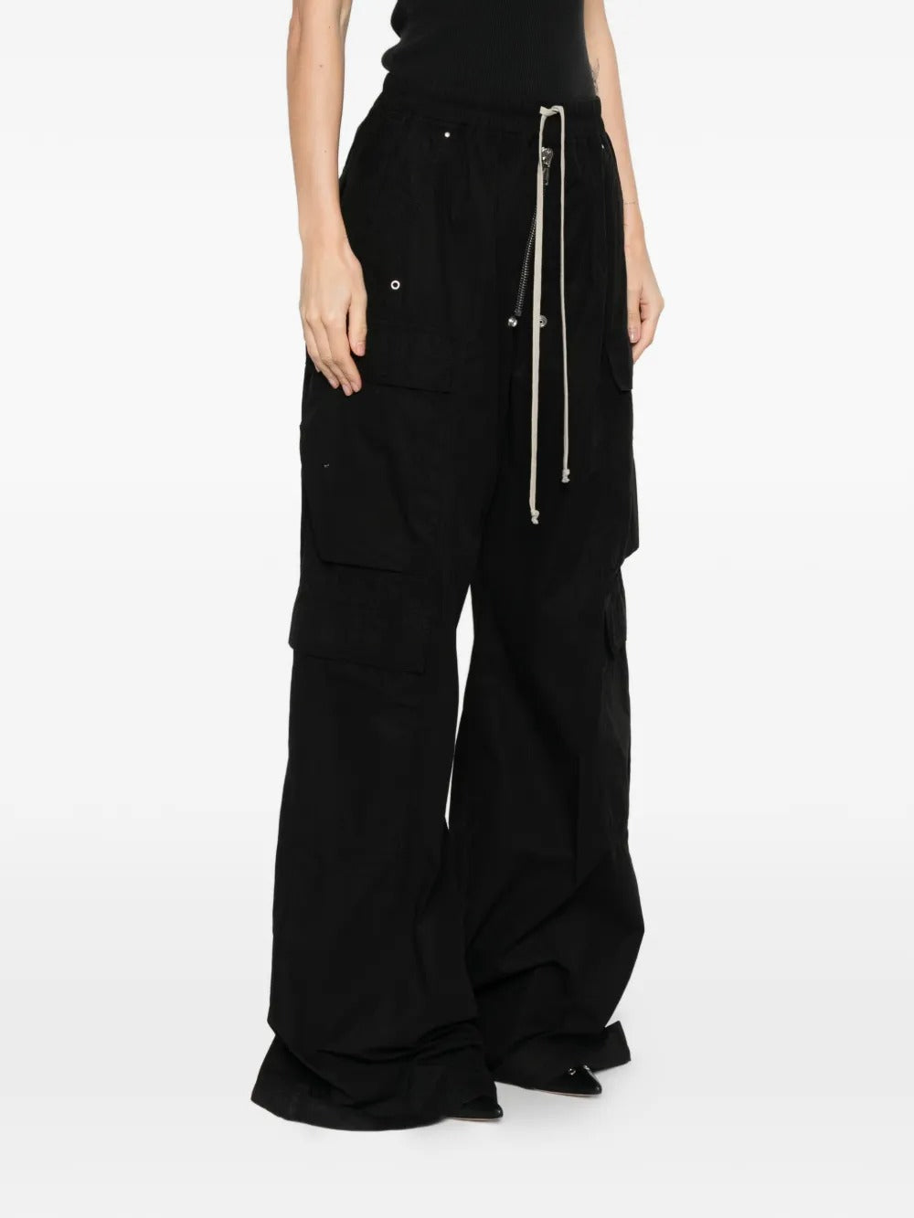 Black pants worn by a person, showing the pants fit