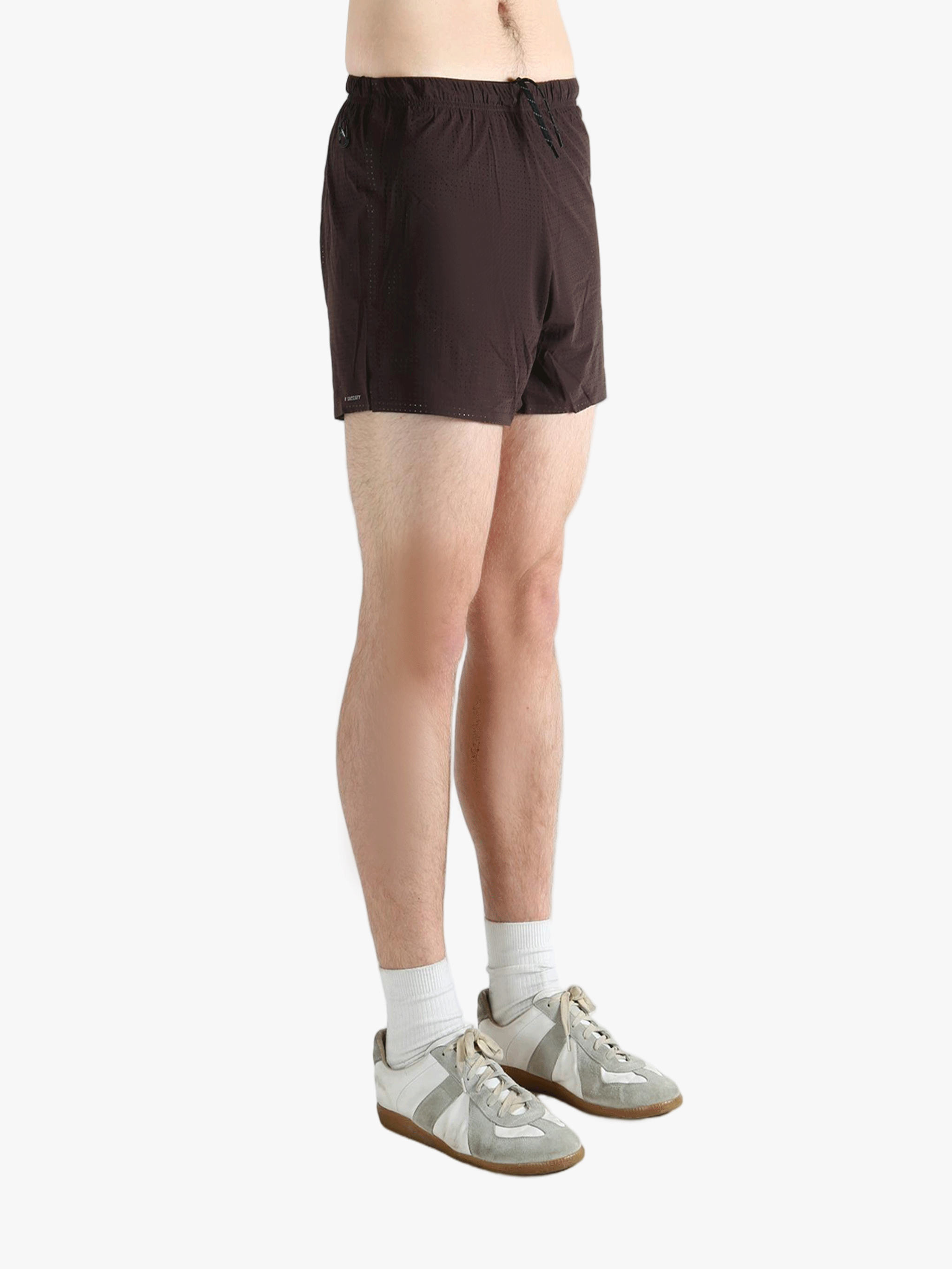 Brown shorts worn by a person, showing the shorts fit