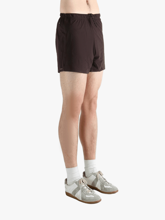 Brown shorts worn by a person, showing the shorts fit