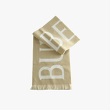 Close up of tan scarve, showing texture of the wool fabric