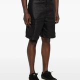 Black shorts worn by a person, showing the black shorts' fit