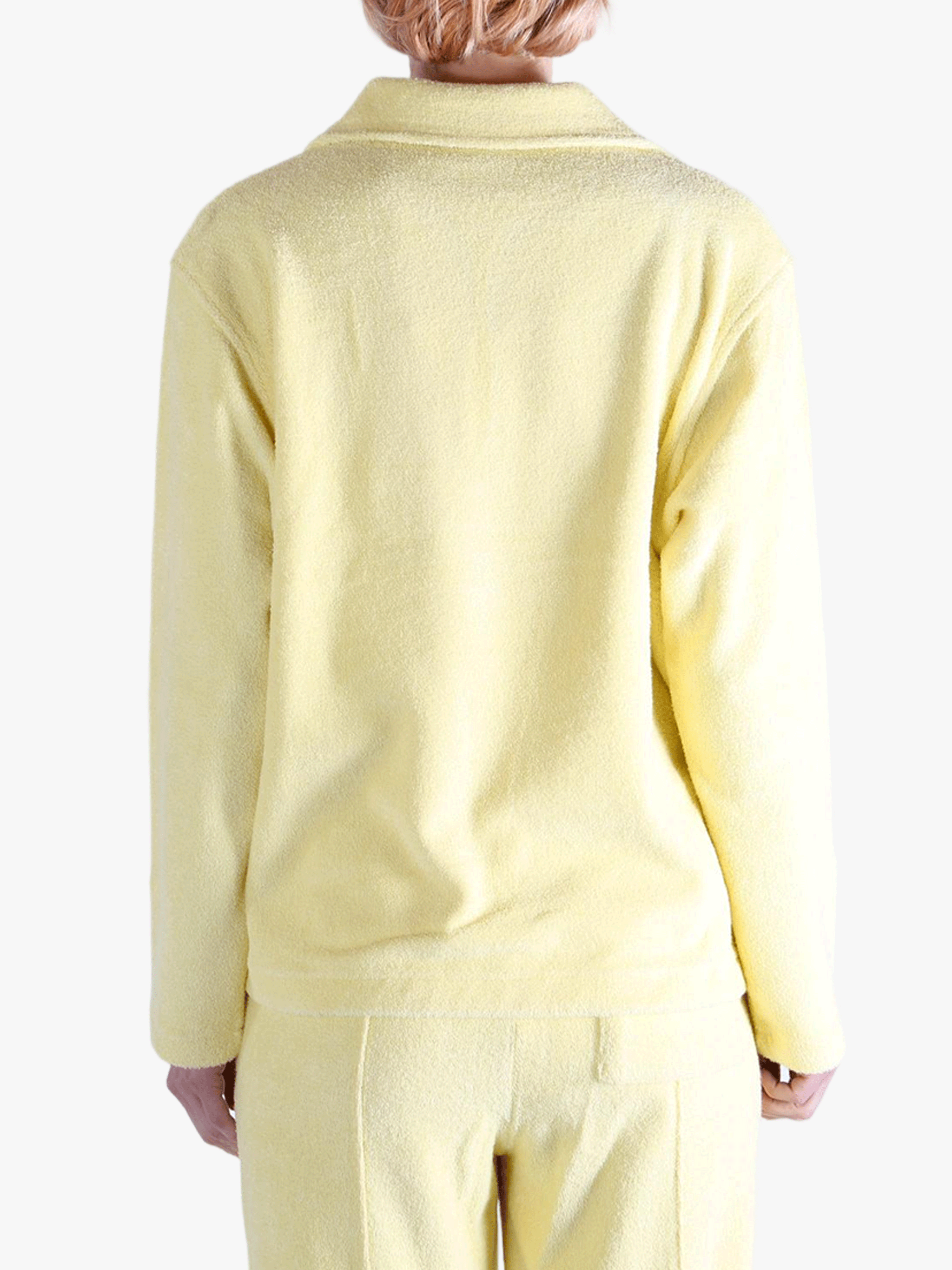 Yellow shirt worn by a person, showing the shirt's fit