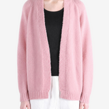 Pink knitwear worn by a person, showing the knitwear fit