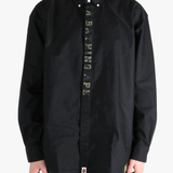 Black shirt worn by a person, showing the shirt's fit