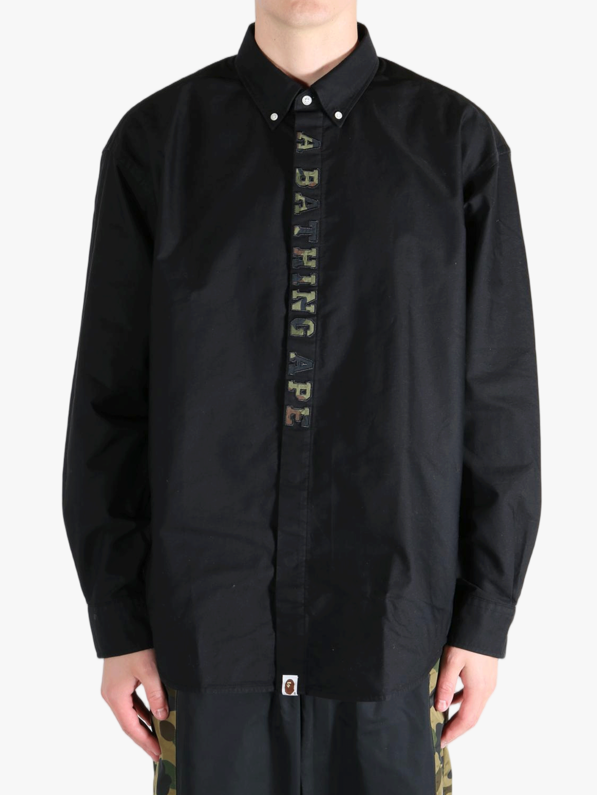 Black shirt worn by a person, showing the shirt's fit