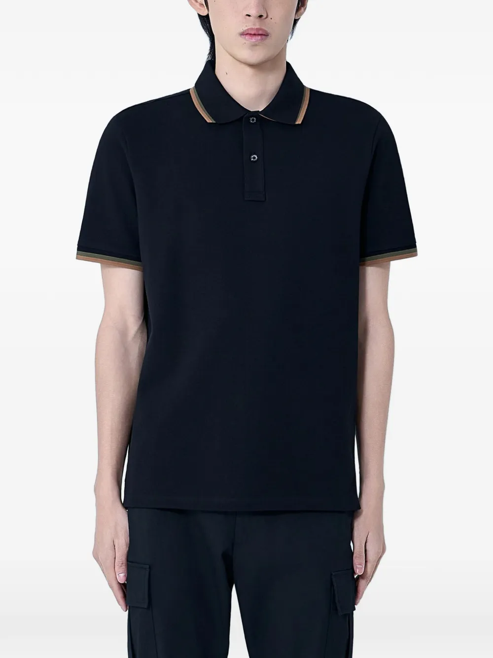 black shirts worn by a person, showing the shirts  fit