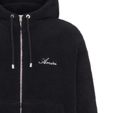 Close up of the black hoodie, showing texture of the polyester fabric