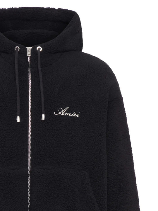 Close up of the black hoodie, showing texture of the polyester fabric