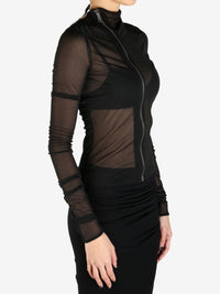 Black coat worn by a person, showing the coat's fit