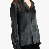 Black shirt worn by a person, showing the shirt's fit