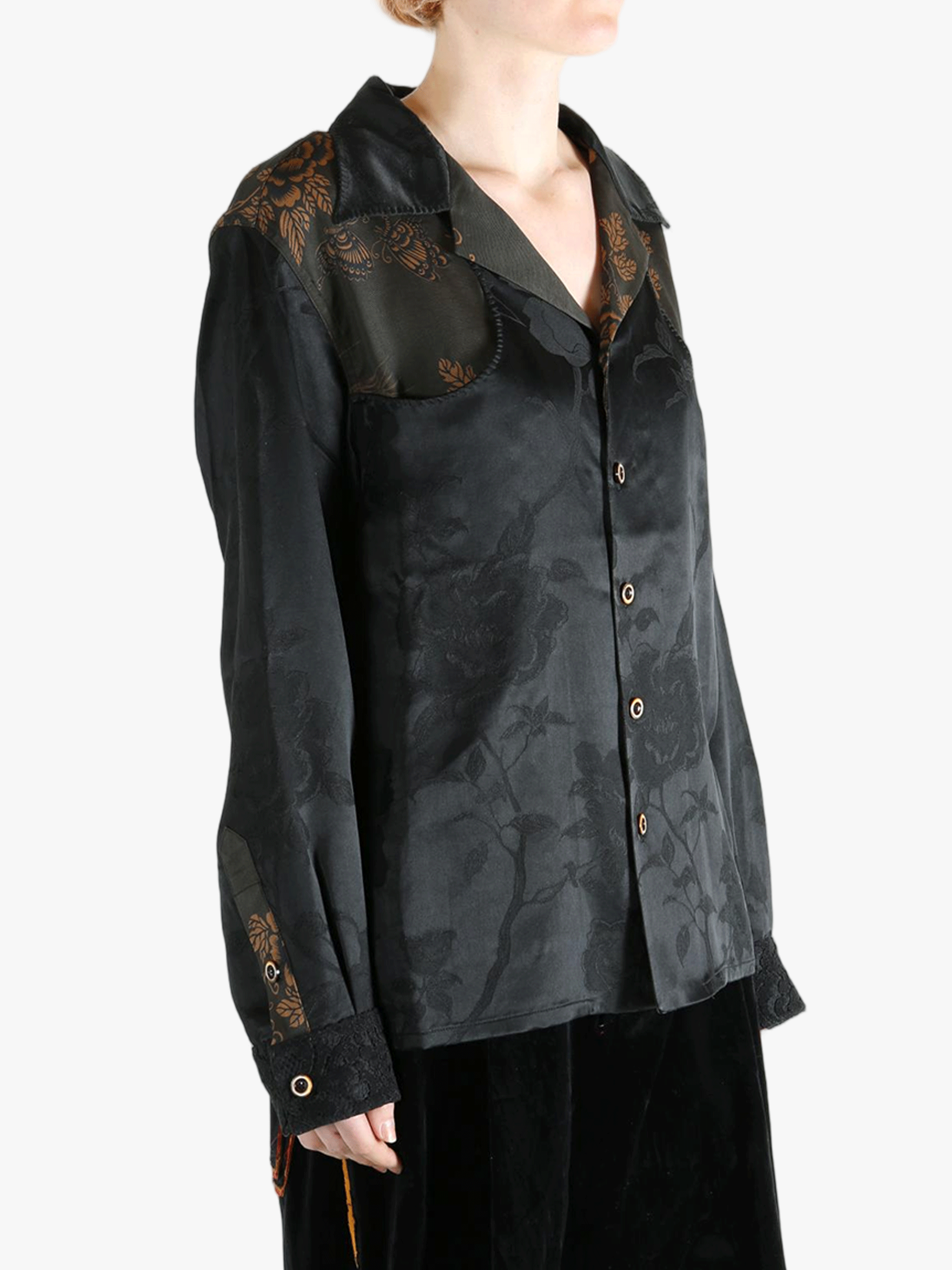 Black shirt worn by a person, showing the shirt's fit