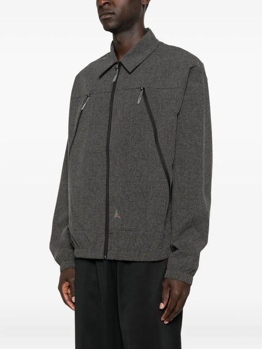 Black shirts worn by a person, showing the shirts fit