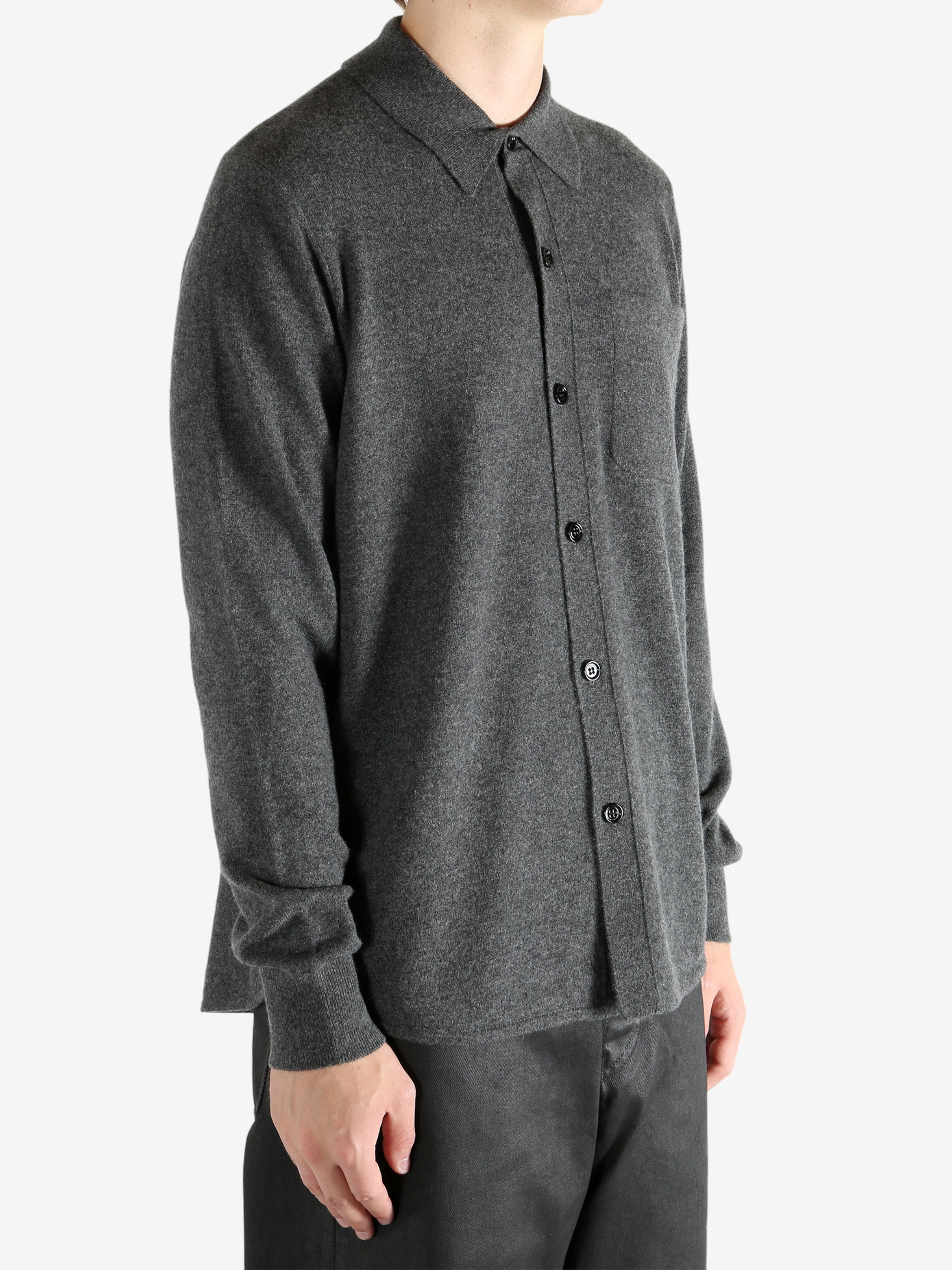 Grey shirt worn by a person, showing the shirt's fit