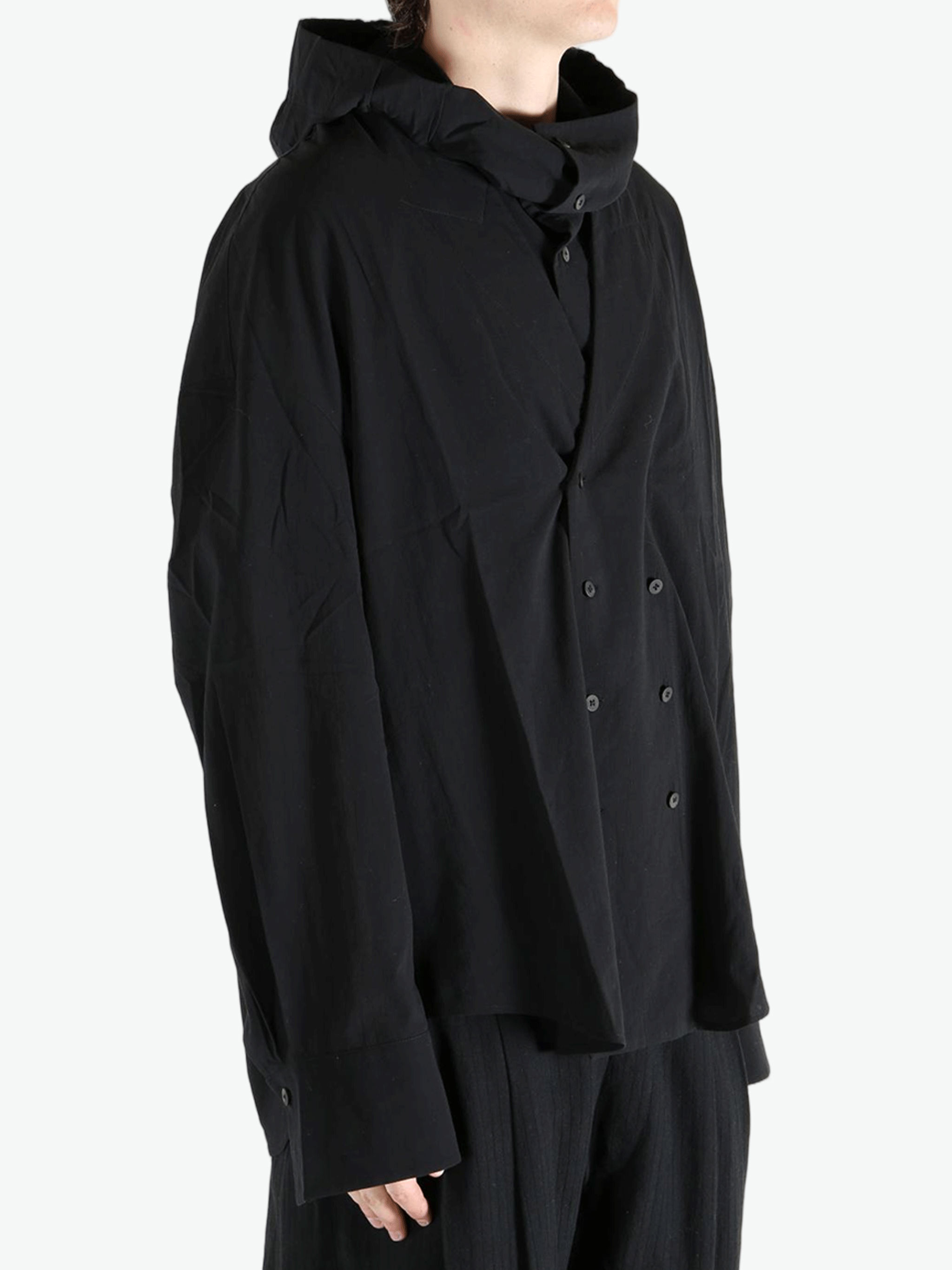 Black shirt worn by a person, showing the shirt's fit